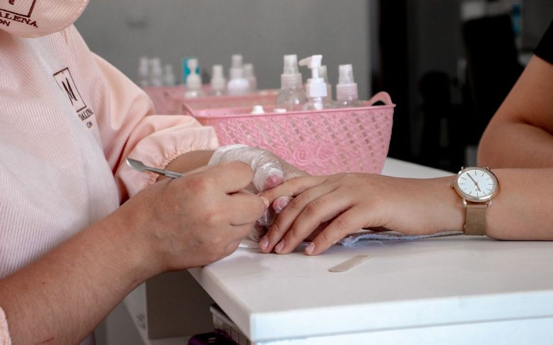 Close-up of a nail technician providing a manicure in a modern beauty salon